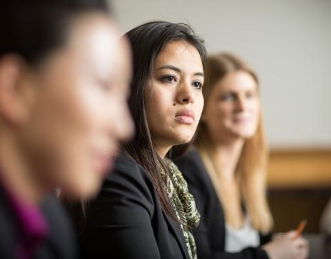 Three UNH law students listening in class