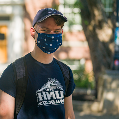 student in UNH branded tee and mask