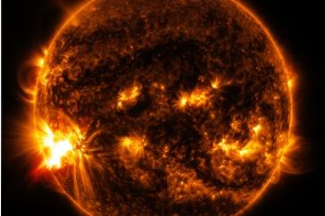 An image of the sun with orange flares on its surface.