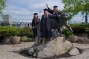 Students surround Wildcat statue during commencement