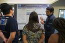 Image of student presenting poster at GRC. 