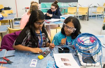 two students at work with wires at tech camp